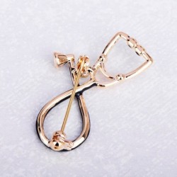 Stethoscope shaped brooch with crystal